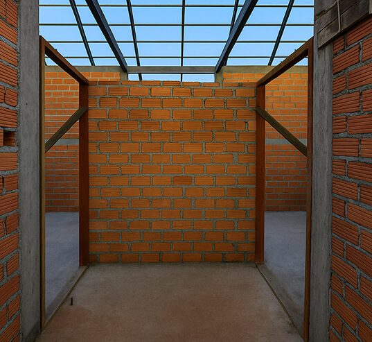 Looks like a half-built brick room—open top with a metal grate, concrete floor, bare brick walls, two doorways on each side.